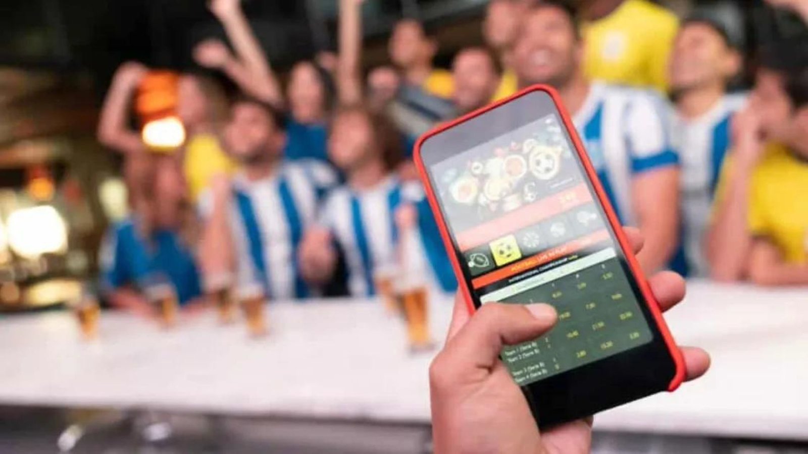 A Man Holding a Smartphone looking a college football betting sites 